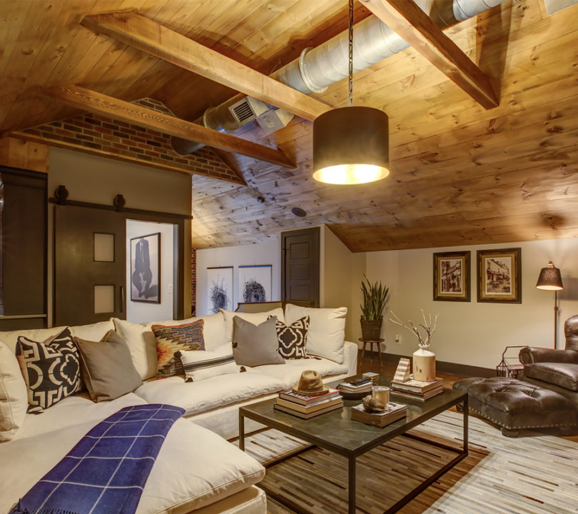 cozy remodeled attic with wood cieling and panels