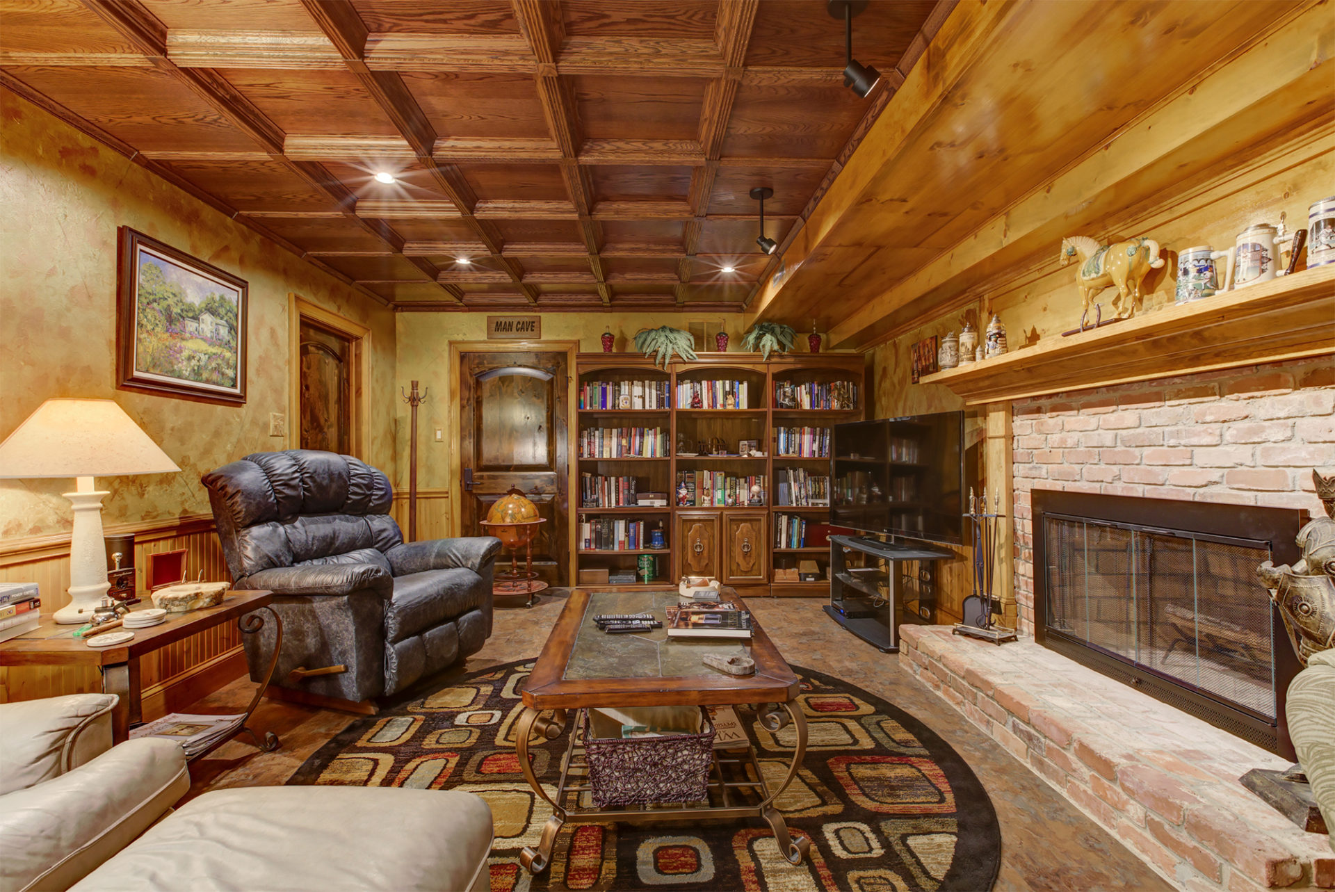 cozy man cave with small library and leather recliner