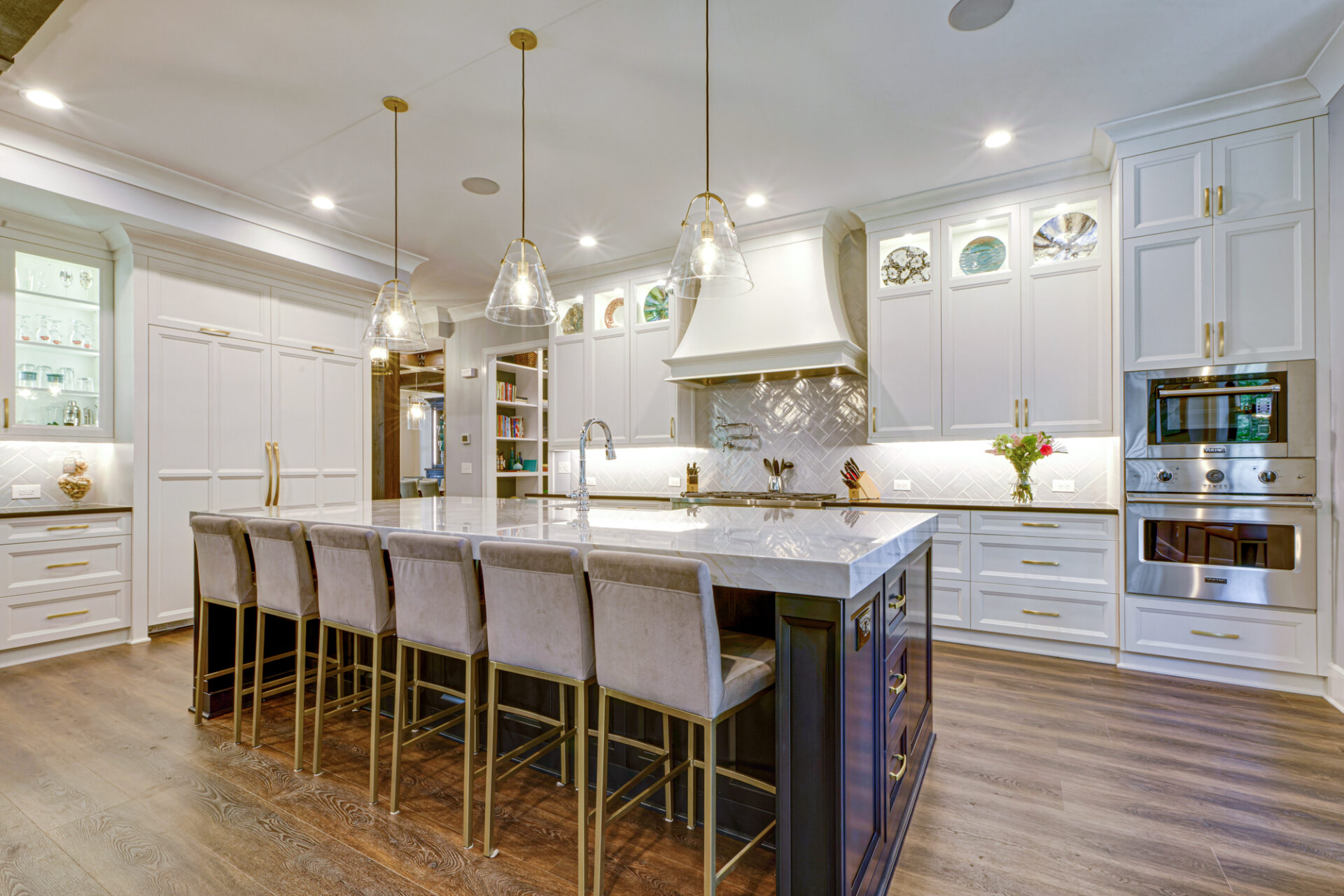 A modern kitchen remodel with white cabinets and quartz countertops